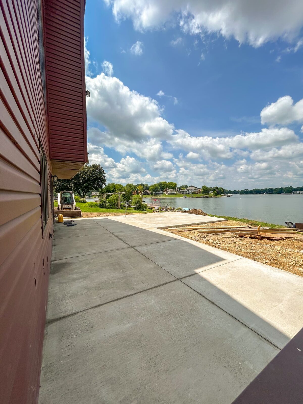 Finished lakeside concrete patio poured by Redeemed Construction